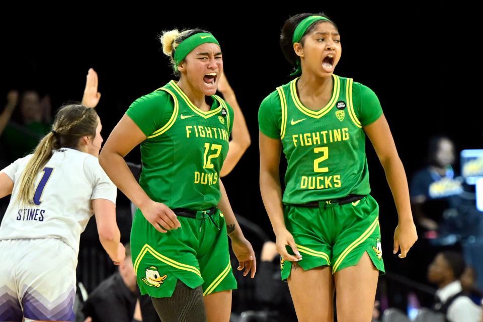 Oregon guard Te-Hina Paopao (12) and guard Chance Gray (2) react after a three-point basket against Washington during the second half of the game in the first round of the Pac-12 women's tournament Wednesday, March 1, 2023, in Las Vegas.