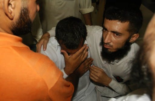 Pakistanis mourn the death of relatives at the hospital after an attack on a police hostel in Lahore on Thursday. Gunmen shot dead nine Pakistani police prison staff as they slept, the second attack on security forces in the country's political heartland since Islamabad reopened a NATO supply corridor