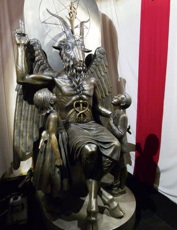 FILE PHOTO: A one-ton, 7-foot (2.13-m) bronze statue of Baphomet -- a goat-headed winged deity that has been associated with satanism and the occult -- is displayed by the Satanic Temple during its opening in Salem, Massachusetts, U.S. September 22, 2016. REUTERS/Ted Siefer