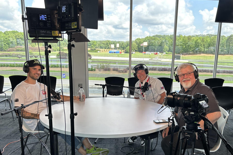 Three announcers sit smiling using Audio-Technica gear for their podcast.