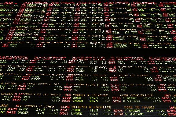 FILE- In this Jan. 27, 2015, file photo, Super Bowl proposition bets are displayed on a board at the Westgate Superbook race and sports book in Las Vegas. Las Vegas casinos can't agree on an NCAA tournament favorite, with favorites changing within hours. (AP Photo/John Locher, File)