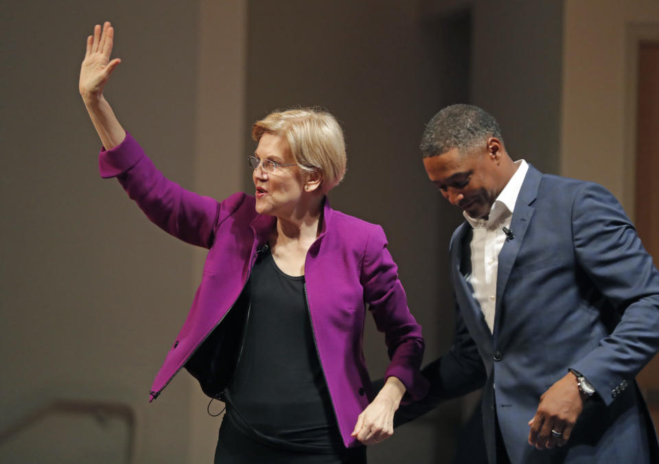 FILE - In this Friday, Aug. 3, 2018, file photo, Sen. Elizabeth Warren, D-Mass., left, greets Rep. Cedric Richmond, D-La., and waves to the crowd as she arrives to speak at a sit-down conversation-styled event at Dillard University in New Orleans. Many of the Democratic Party’s most ambitious have begun building relationships in the states most responsible for picking the party’s next presidential nominee. Warren is in the midst of her own re-election campaign, as well as a midterm blitz to help other Democrats nationwide win their races. (AP Photo/Gerald Herbert, File)