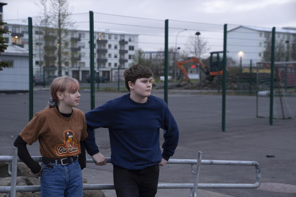 This photo taken Monday, May 13, 2019, Karen Guttensen and Ingvar Ingolfsson, right, both 14-years old, outside the Tjornin youth center in Reykjavik, Iceland, on a bright summer night. The island nation in the North Atlantic has dried up a teenage culture of drinking and smoking by focusing on local participation in music and sports options for students, with such success that Icelandic teens now have one of the lowest rates of substance abuse in Europe. (AP Photo/Egill Bjarnason)