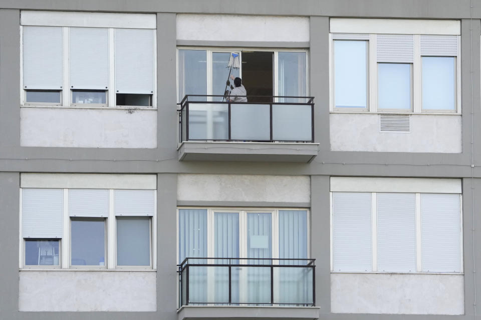 A worker cleans a window on the last floor of Rome's Agostino Gemelli University Polyclinic, Thursday, June 8, 2023, where Pope Francis underwent surgery Wednesday. Pope Francis awoke Thursday after a good first night in the hospital following a three-hour operation to remove intestinal scar tissue and repair a hernia in his abdominal wall, problems that developed following previous surgeries. (AP Photo/Andrew Medichini)