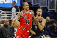 Chicago Bulls forward DeMar DeRozan (11) drives against Orlando Magic guard Jalen Suggs (4) during the first half of an NBA basketball game Saturday, Jan. 28, 2023, in Orlando, Fla. (AP Photo/Kevin Kolczynski)