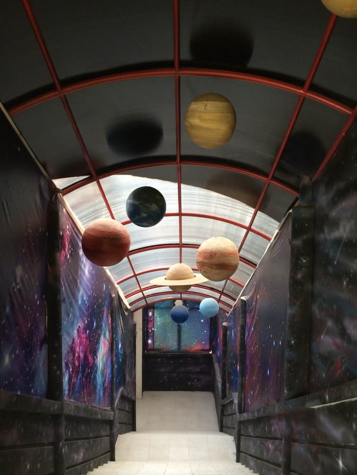 Galaxy corridor: As we descended the stairs into a corridor, we were greeted by planets hung on the ceiling and dark walls dotted with varied colors to imitate the sight of an outer space galaxy, immediately setting our mood for fun and adventure.