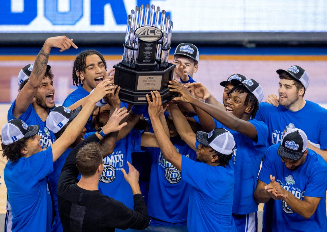 Duke coach Jon Scheyer celebrates with his team and the ACC Tournament Championship trophy following their 59-49 victory over Virginia on Saturday, March 11, 2023 at the Greensboro Coliseum in Greensboro, N.C.