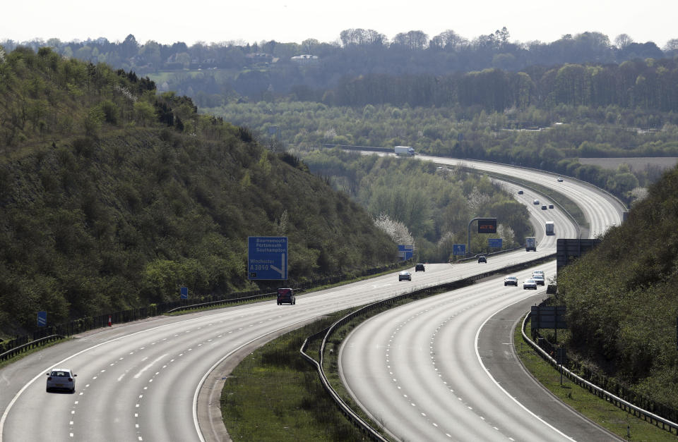 Cars make their way along the almost empty M3 motorway, that would normally carry thousands of holiday makers for this long holiday weekend, near to Winchester, England, as the UK continues in lockdown to help curb the spread of the coronavirus, Friday April 10, 2020. The highly contagious COVID-19 coronavirus has impacted on nations around the globe, many imposing self isolation and exercising social distancing when people move from their homes. (Andrew Matthews / PA via AP)