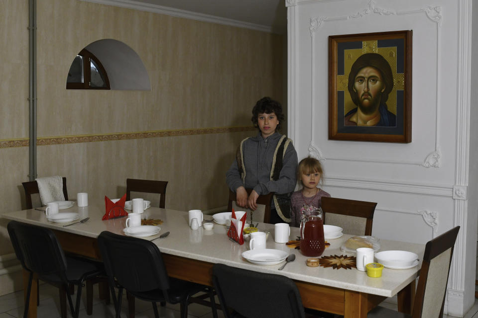 Children wait for a meal in the Orthodox Skete in honor of St. John of Shanghai in Adamivka, near Slovyansk, Donetsk region, Ukraine, Tuesday, May 10, 2022. (AP Photo/Andriy Andriyenko)