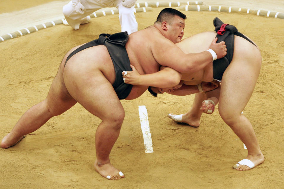 FILE - In this July 19, 2005, file photo, Sumo wrestler Takayuki Ichihara from Japan, left, fights against compatriot Keisho Shimoda in the heavyweight final of the Sumo tournament at the World Games in Duisburg, Germany. Joining the array of postponed events in the midst of the coronavirus pandemic, officials announced Thursday that the 11th edition of the World Games in Birmingham, Alabama will now be held in the summer of 2022. (AP Photo/Martin Meissner, FIle)