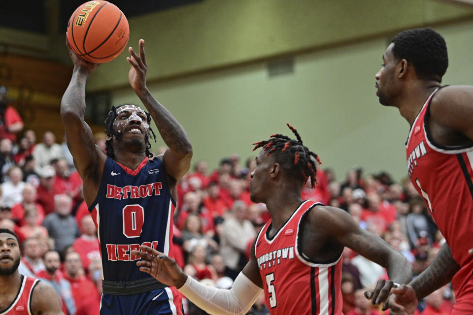 Detroit Mercy guard Antoine Davis shoots over Youngstown State guard Dwayne Cohill during the first half of an NCAA college basketball game in the quarterfinals of the Horizon League tournament Thursday, March 2, 2023, in Youngstown, Ohio. (AP Photo/David Dermer)