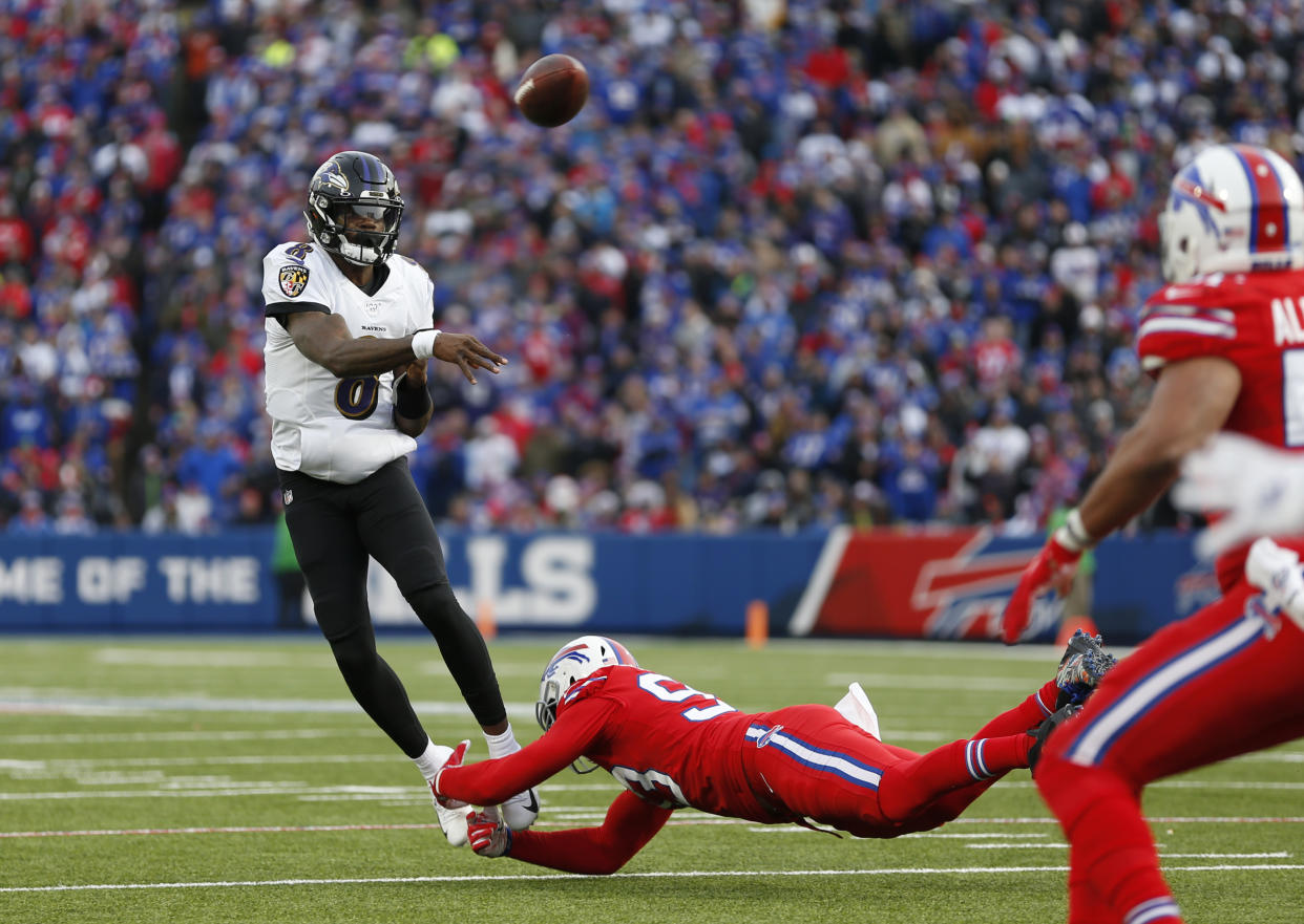 ORCHARD PARK, NY - DECEMBER 8:  Trent Murphy #93 of the Buffalo Bills dives to try and make a tackle on Lamar Jackson #8 of the Baltimore Ravens as he throws a pass during the second half at New Era Field on December 8, 2019 in Orchard Park, New York.  Baltimore beats Buffalo 24 to 17. (Photo by Timothy T Ludwig/Getty Images)