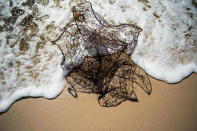 <p>An abandoned crab trap rest on the beach surf in Tangier, Virginia, May 15, 2017, where climate change and rising sea levels threaten the inhabitants of the slowly sinking island.<br> (Jim Watson/AFP/Getty Images) </p>