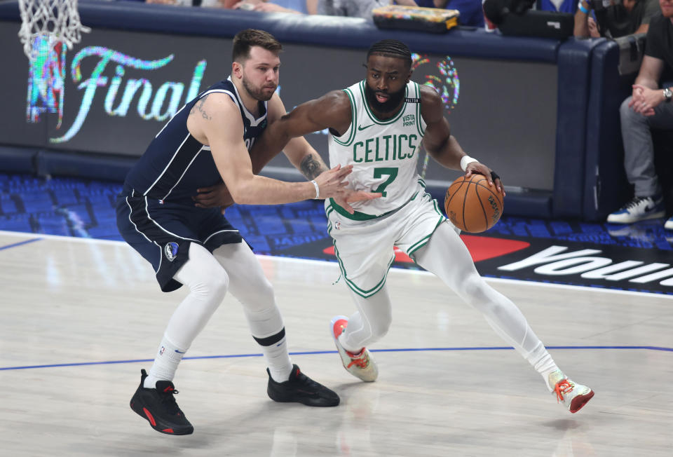 DALLAS, TEXAS - JUNE 14: Jaylen Brown #7 of the Boston Celtics drives to the basket against Luka Doncic #77 of the Dallas Mavericks during the first quarter in Game Four of the 2024 NBA Finals at American Airlines Center on June 14, 2024 in Dallas, Texas. NOTE TO USER: User expressly acknowledges and agrees that, by downloading and or using this photograph, User is consenting to the terms and conditions of the Getty Images License Agreement. (Photo by Tim Heitman/Getty Images)