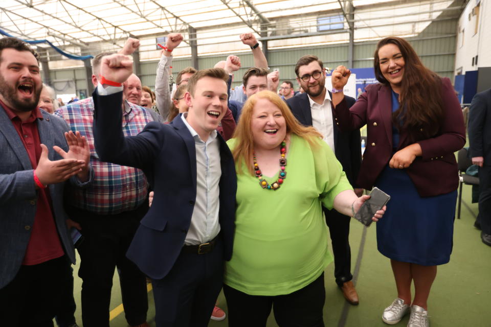 Naomi Long, centre, leader of the Alliance party celebrates with party members after there party success in the elections at the Medow Bank election count centre on Saturday, May, 7, 2022, in Magherafelt , Northern Ireland. (AP Photo/Peter Morrison)