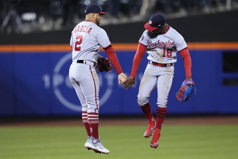 Washington Nationals' Luis Garcia (2) celebrates with Victor Robles (16) after the team's 5-0 win in a baseball game against the New York Mets on Tuesday, April 25, 2023, in New York. (AP Photo/Frank Franklin II)
