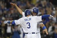 Los Angeles Dodgers' Chris Taylor hugs Albert Pujols after his two-run home run against the Atlanta Braves during the fifth inning in Game 5 of baseball's National League Championship Series Thursday, Oct. 21, 2021, in Los Angeles.(AP Photo/Jae C. Hong)