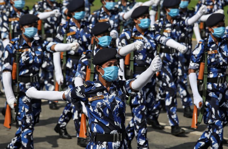 Members of the Rapid Action Force (RAF) of Kolkata police wearing face masks take part in rehearsal for the Independence Day parade, after authorities eased lockdown restrictions that were imposed to slow the spread of the coronavirus disease, in Kolkata