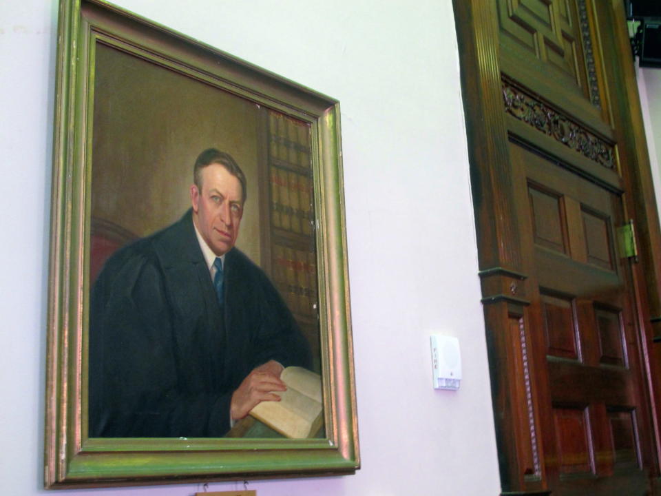 A painting of U.S. District Judge Waites Waring, one of three federal judges to hear a key school desegregation case from Clarendon County, S.C., in 1951, hangs in the courtroom where the case was heard in the federal courthouse in Charleston, S.C., on April 3, 2014. Waring was the first judge to write an opinion that separate schools are not equal schools since separate but equal became the law of the land in the late 1800s. A statue of Waring is being dedicated outside the courthouse on April 11, 2014. (AP Photo/Bruce Smith)