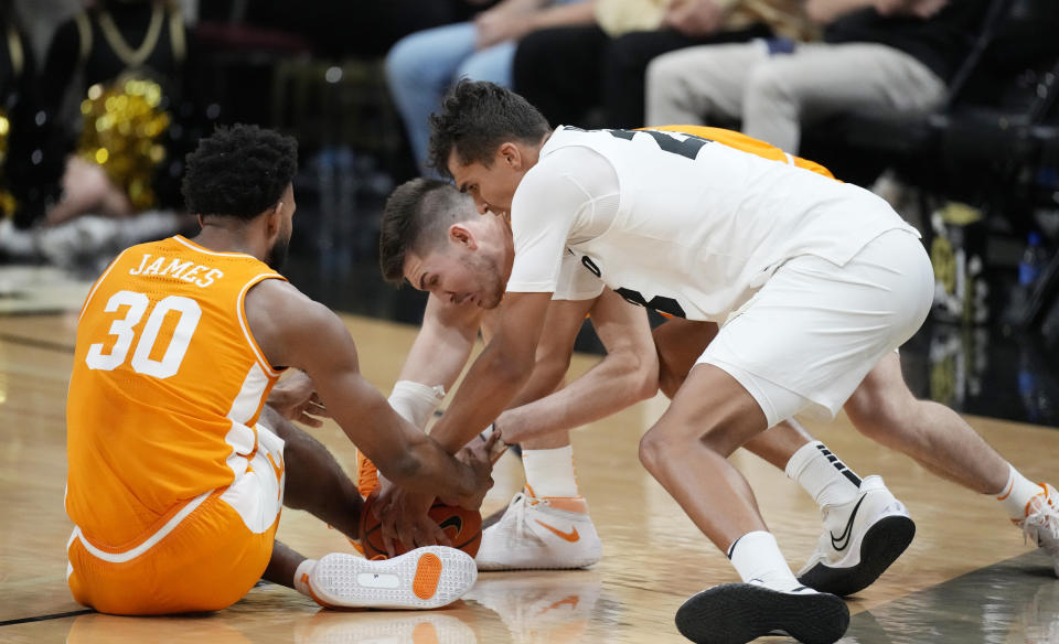 Colorado forward Tristan da Silva, front right, fights to recover a loose ball with Tennessee forward John Fulkerson, back right, and guard Josiah-Jordan James in the first half of an NCAA college basketball game Saturday, Dec. 4, 2021, in Boulder, Colo. (AP Photo/David Zalubowski)