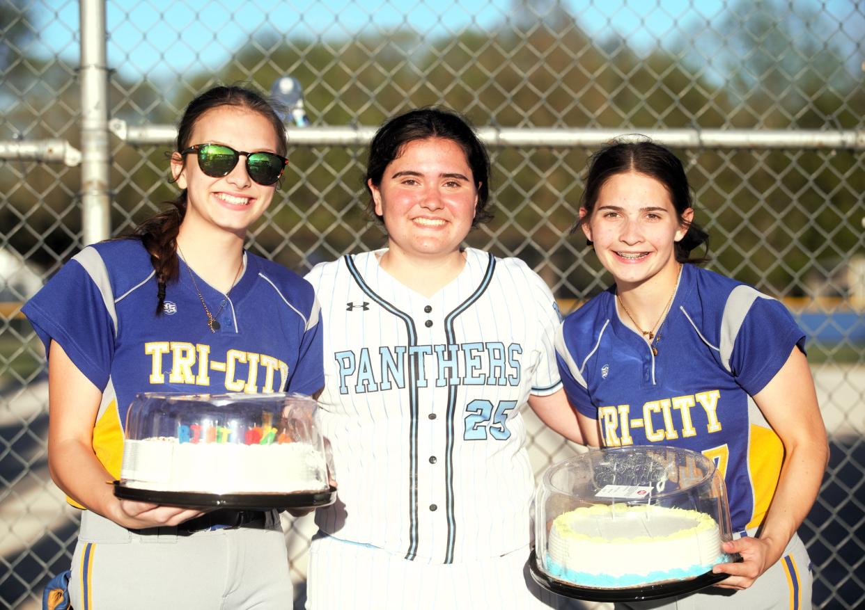 North Mac's Ines Ortigosa, middle, received a birthday surprise from Buffalo Tri-City's Lily Woodworth, left, and Lexie Patton, right, following a nonconference softball game in Buffalo on Wednesday. Ortigosa is a foreign exchange student from Spain.