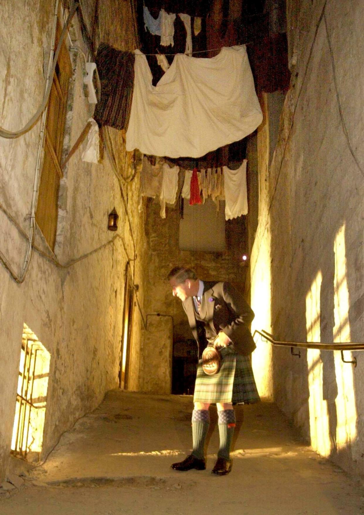 Britain's Prince of Wales walks through and examines The Real Mary
King's Close at the Royal Mile, Edinburgh, June 10, 2003. The visit was
part of a day of activities which members of the Royal Family took part
in designed to promote Britiain's flagging tourism trade.
REUTERS/Andrew Milligan/POOL

MD/JV