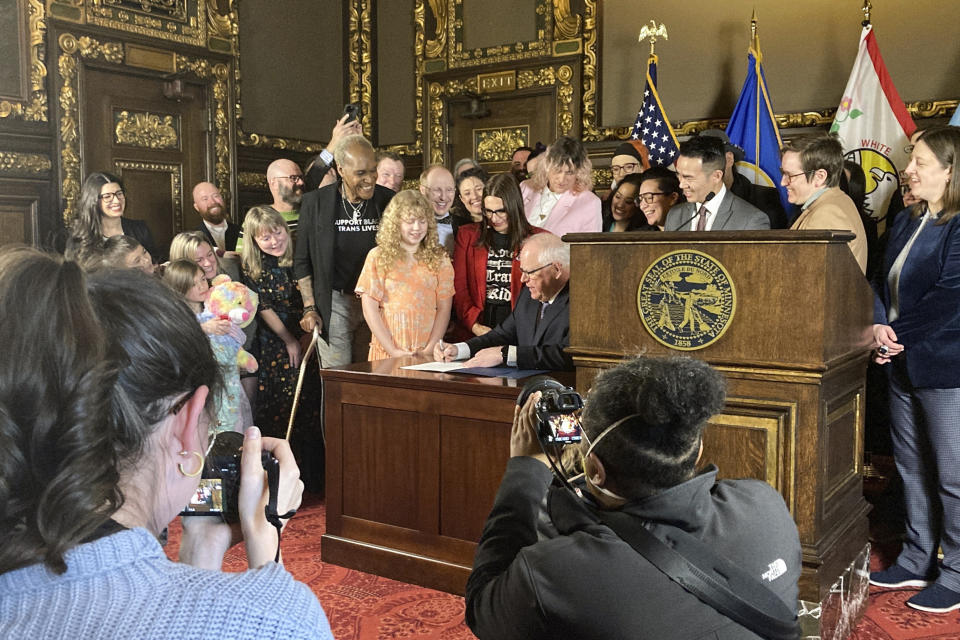 Democratic Minnesota Gov. Tim Walz signs an executive order on Wednesday, March 8, 2023, at the State Capitol in St. Paul, Minn., to protect the rights of LGBTQ people from Minnesota and other states to receive gender affirming health care. (AP Photo/Steve Karnowski)