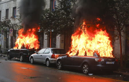 Cars are set on fire by protesters during a rally against Expo 2015 in Milan, May 1, 2015. REUTERS/Stefano Rellandini TPX IMAGES OF THE DAY