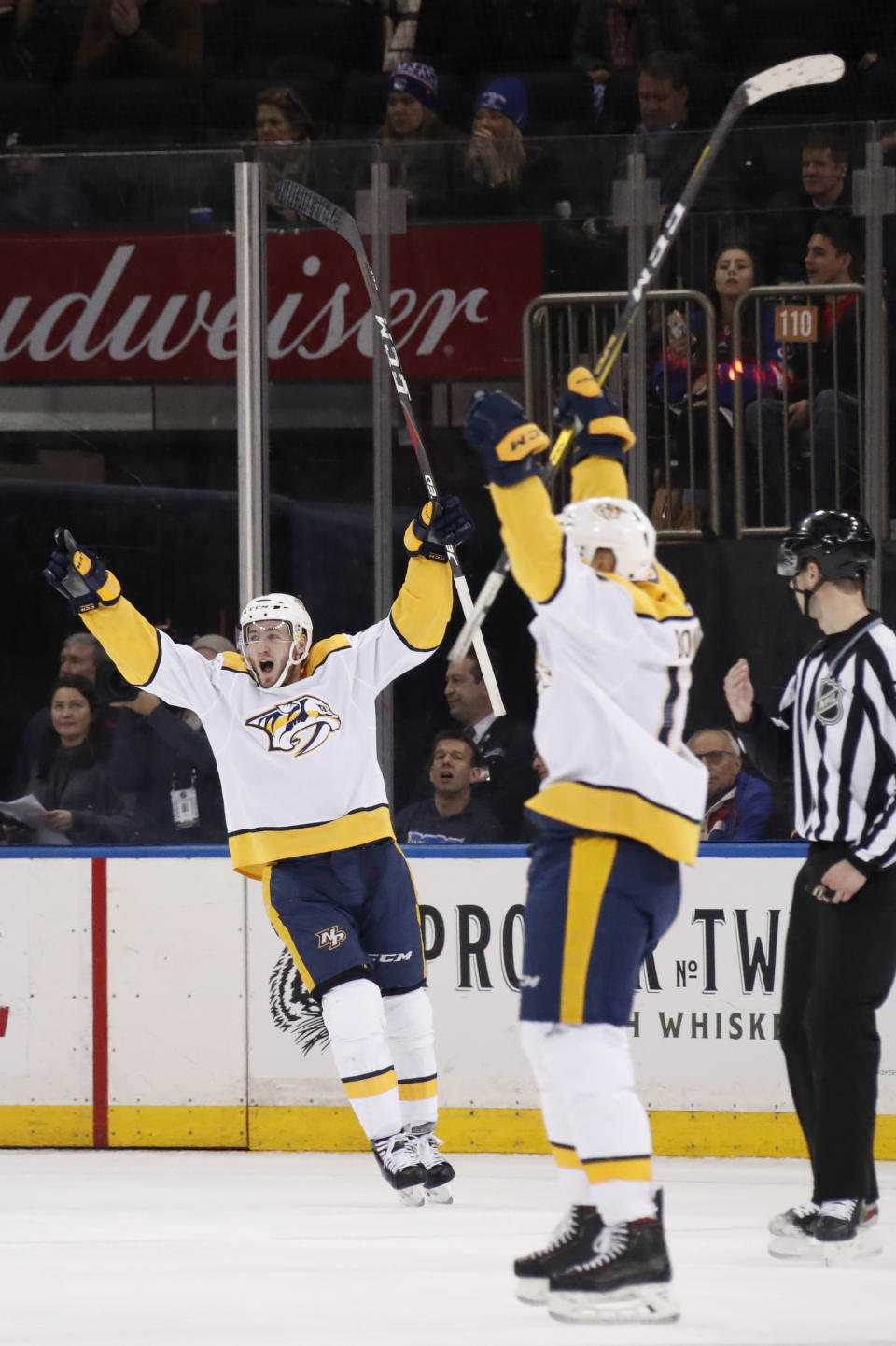 Nashville Predators center Colton Sissons (10) and Nashville Predators center Nick Bonino (13) celebrate after Nashville Predators defenseman Mattias Ekholm, not shown, scored a goal during the second period of an NHL hockey game, Monday, Dec. 16, 2019, in New York. (AP Photo/Kathy Willens)