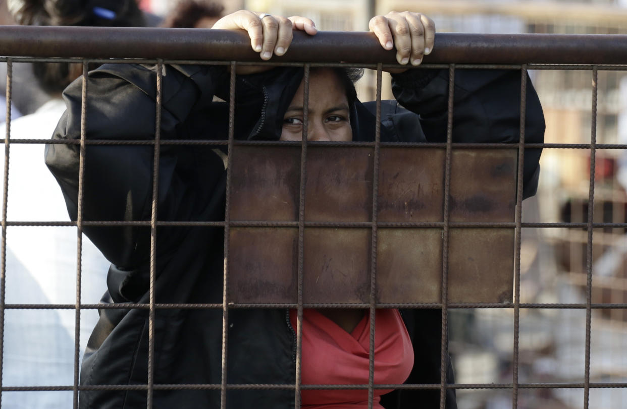 A relative of an inmate awaits news outside the Litoral Penitentiary in Guayaquil, Ecuador, Wednesday, September 29, 2021. The authorities report at least 100 dead and 52 injured in a riot on Tuesday in the prison. (AP Photo/Angel DeJesus)