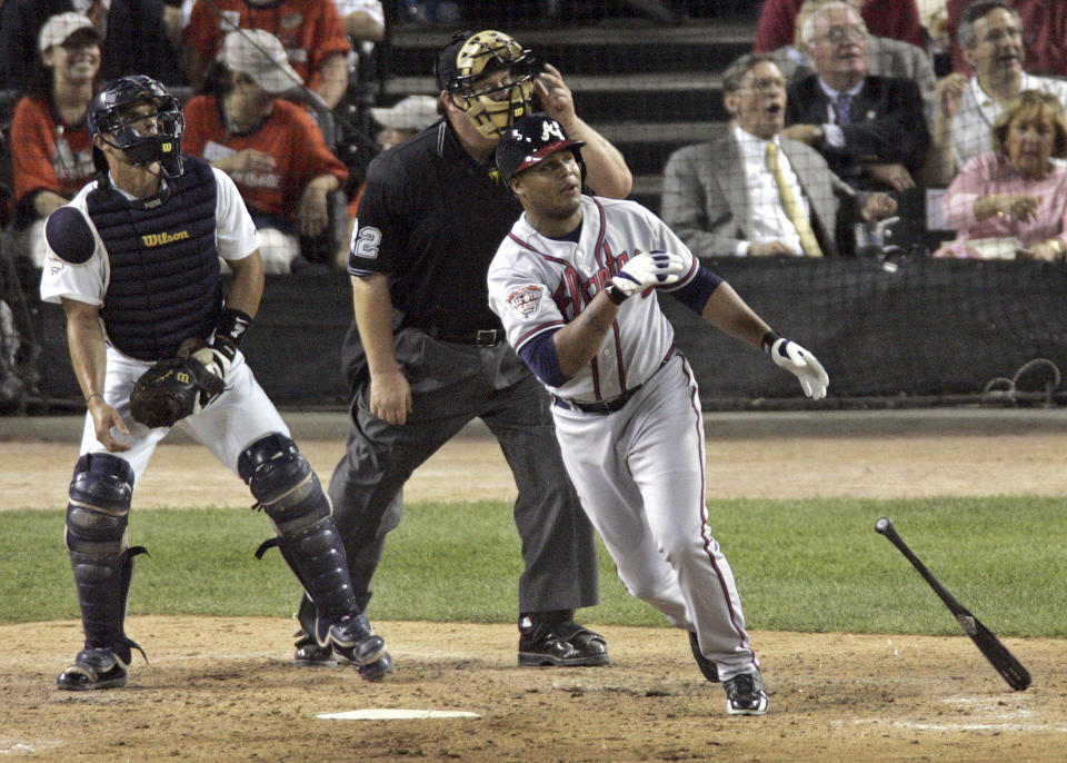 FILE - National League All-Star Andruw Jones of the Atlanta Braves watches his two-run home run off Kenny Rogers of the Texas Rangers in the seventh inning of the 2005 MLB All-Star Game, at Comerica Park in Detroit, on July 12, 2005. The Atlanta Braves will retire No. 25 in honor of Jones later this season. The Braves announced Monday, April 3, 2023, the outfielder will be honored in a special number retirement ceremony Sept. 9. During his 12 seasons with the Braves, Jones won 10 consecutive Gold Glove Awards. He was voted to the All-Star Team five times. (AP Photo/Charlie Neibergall, File)