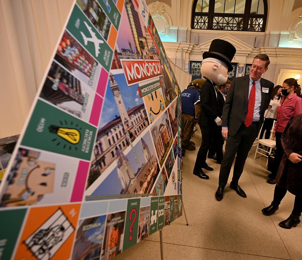 City Manager Edward M. Augustus Jr. admires the new Worcester Edition Monopoly game at Union Station.