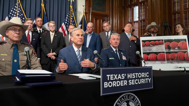 PHOTO: Texas Republican Governor Greg Abbott signs several bills to strengthen Texas border security, June 8, 2023, including deployment of a 1000-foot floating barrier in the middle of the Rio Grande where groups of migrants try to cross. (Credit: Zuma Press/Alamy Live News via AP)