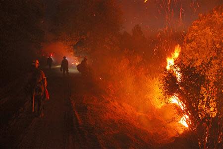Monterey firefighters hold the line at the Rim Fire at night in this undated United States Forest Service handout photo near Yosemite National Park, California, released to Reuters August 30, 2013. REUTERS/Mike McMillan/U.S. Forest Service/Handout via Reuters