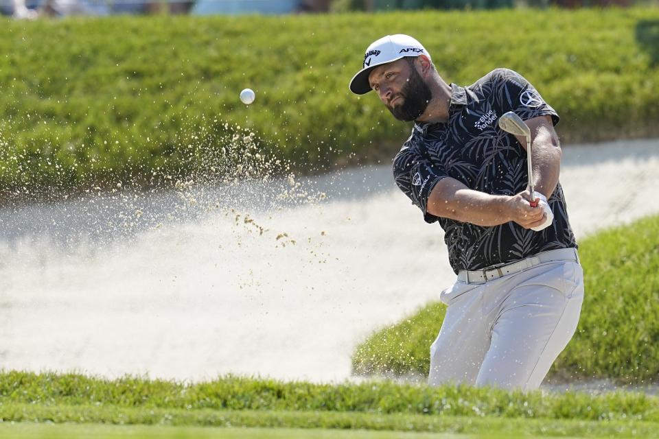 Jon Rahm, of Spain, hits out of a bunker to the 18th green during the first round of the Memorial golf tournament, Thursday, June 1, 2023, in Dublin, Ohio. (AP Photo/Darron Cummings)