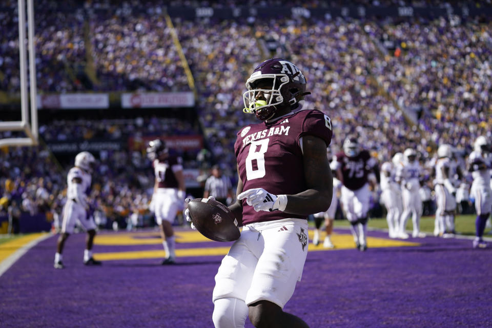 Texas A&M running back Le'Veon Moss (8) carries for a touchdown in the first half of an NCAA college football game against LSU in Baton Rouge, La., Saturday, Nov. 25, 2023. (AP Photo/Gerald Herbert)