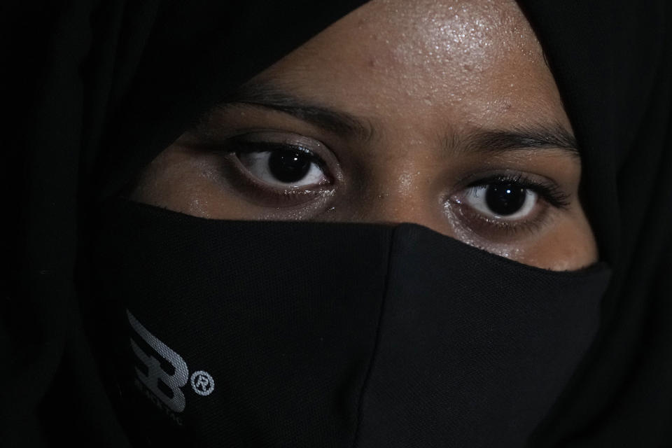 Ayesha Imtiaz, an Indian Muslim student barred from school for wearing hijab sits for an interview with the Associated Press at a cafe in Udupi, Karnataka state, India, Thursday, Feb. 24, 2022. Muslim students in this southern Indian state have found themselves at the center of a debate over hijab bans in schools. Imtiaz, said she wears it as a token of devotion to Islam but acknowledged that opinions vary even among Muslim women. "There are so many of my friends who do not wear hijab inside the classroom," said Imtiaz, 20. "They feel empowered in their own way, and I feel empowered in my own way." (AP Photo/Aijaz Rahi)