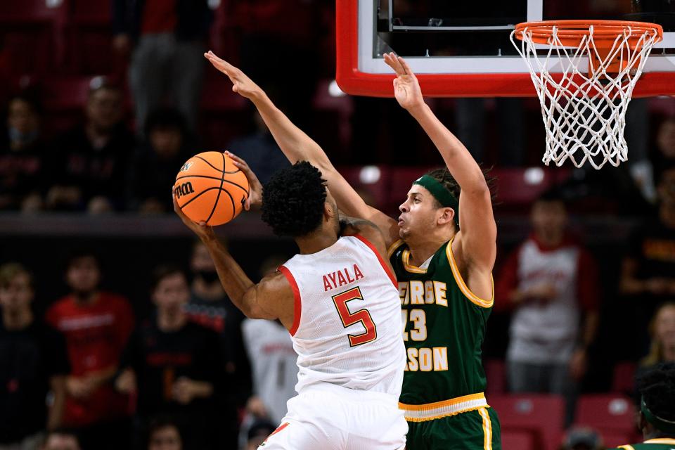 George Mason forward Josh Oduro defends against Maryland's Eric Ayala during a game in the 2021-22 season.