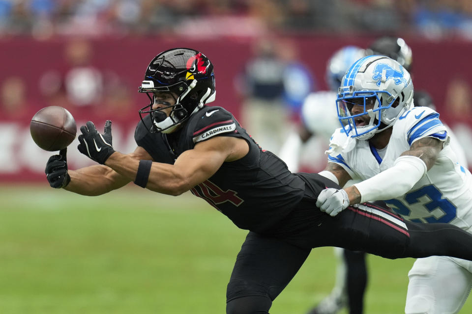 Arizona Cardinals wide receiver Michael Wilson (14) catches a pass as Detroit Lions cornerback Carlton Davis III (23) defends during the first half of an NFL football game Sunday, Sept. 22, 2024, in Glendale, Ariz. (AP Photo/Ross D. Franklin )