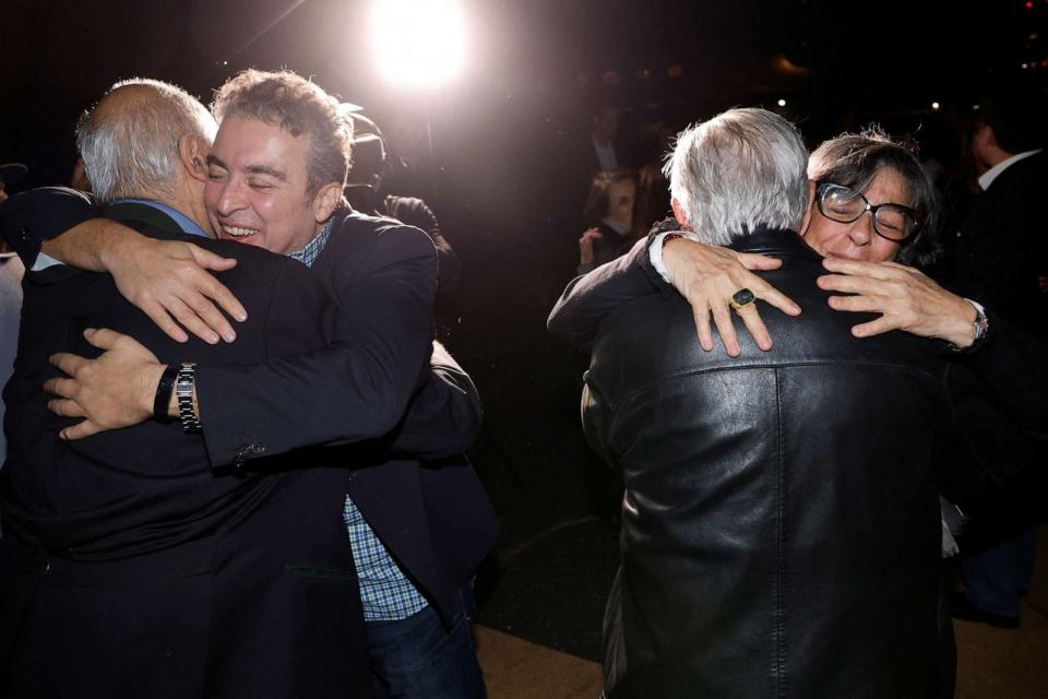 PHOTO: Family members embrace freed Americans Siamak Namazi, Morad Tahbaz and Emad Shargi as well as two returnees whose names have not yet been released by the U.S. government at Davison Army Airfield at Fort Belvoir, Va., Sept. 19, 2023. (Jonathan Ernst/Reuters)