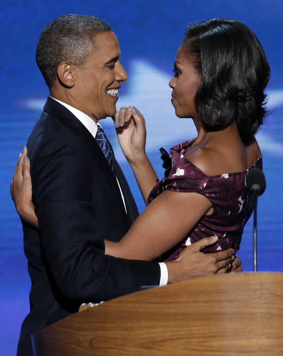 President Barack Obama hugs his wife Michelle before addressing the Democratic National Convention in Charlotte, N.C., on Thursday, Sept. 6, 2012. (AP Photo/J. Scott Applewhite)