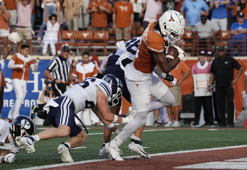 Texas wide receiver Adonai Mitchell, right, runs for a touchdown against BYU during the second half of an NCAA college football game in Austin, Texas, Saturday, Oct. 28, 2023. (AP Photo/Eric Gay)