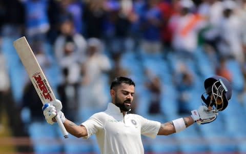 Virat Kohli celebrates reaching his century - Credit: ap