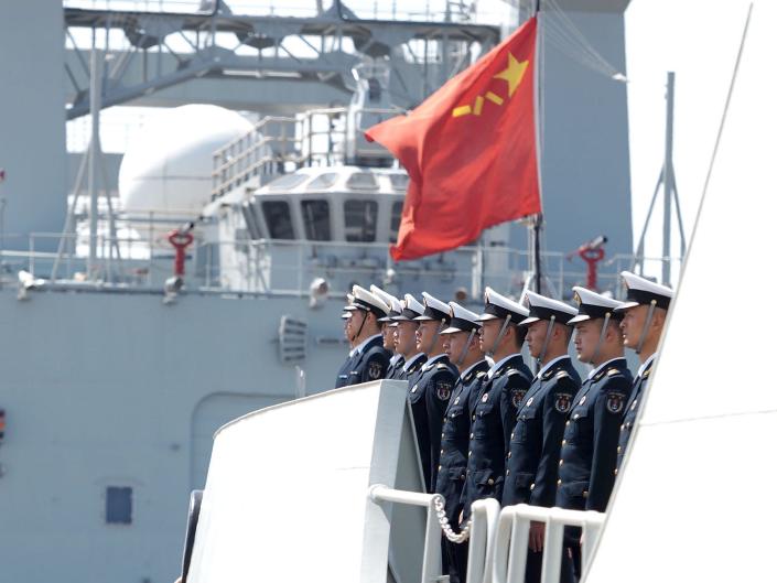 Officers and soldiers of the Chinese naval fleet for escort mission line up on the deck at a port in Zhoushan, east China's Zhejiang Province, April 28, 2020.