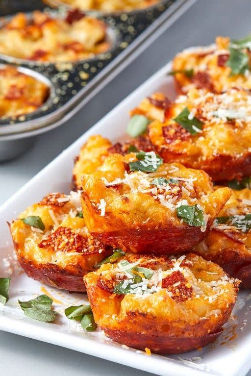 <p>No forks are needed for these baked mac and cheese bites are held together by pepperoni.</p><p>Get the <a href="https://www.delish.com/cooking/recipe-ideas/a30644454/mac-and-cheese-pizza-bites-recipe/" rel="nofollow noopener" target="_blank" data-ylk="slk:Mac & Cheese Pizza Bites recipe;elm:context_link;itc:0;sec:content-canvas" class="link "><strong>Mac & Cheese Pizza Bites recipe</strong></a> from Delish. </p>