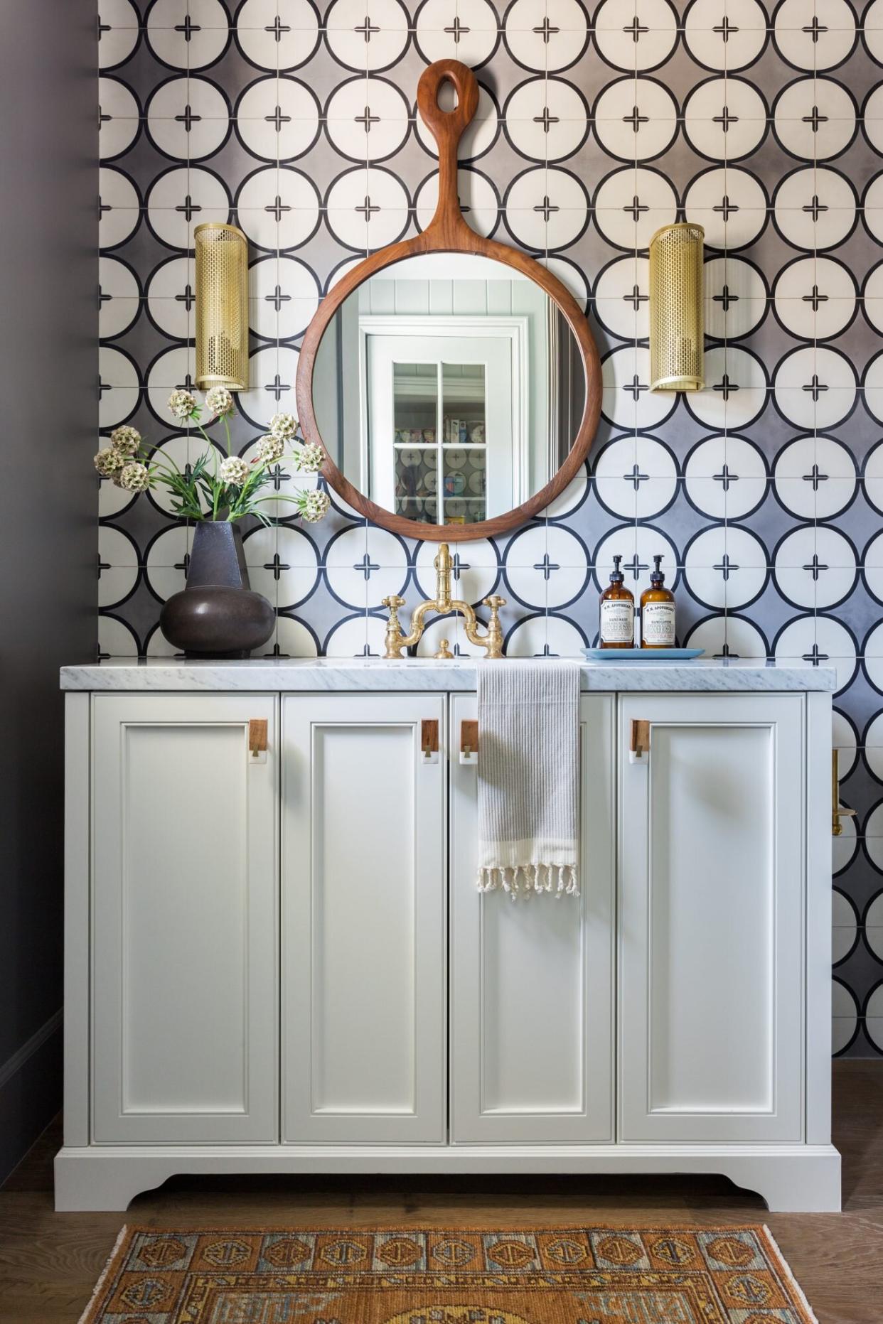 Circular Patterned blue tiles in powder room with white vanity