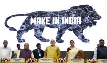 FILE - Indian Prime Minister Narendra Modi, center, unveils the logo of 'Make in India' initiative in New Delhi, India, Sept. 25, 2014. India's phenomenal transformation from an impoverished nation in 1947 into an emerging global power whose $3 trillion economy is Asia's third largest has made it a major exporter of things like software and vaccines. The country marks 75 years of independence from British rule on Aug. 15. (AP Photo/Saurabh Das, File)