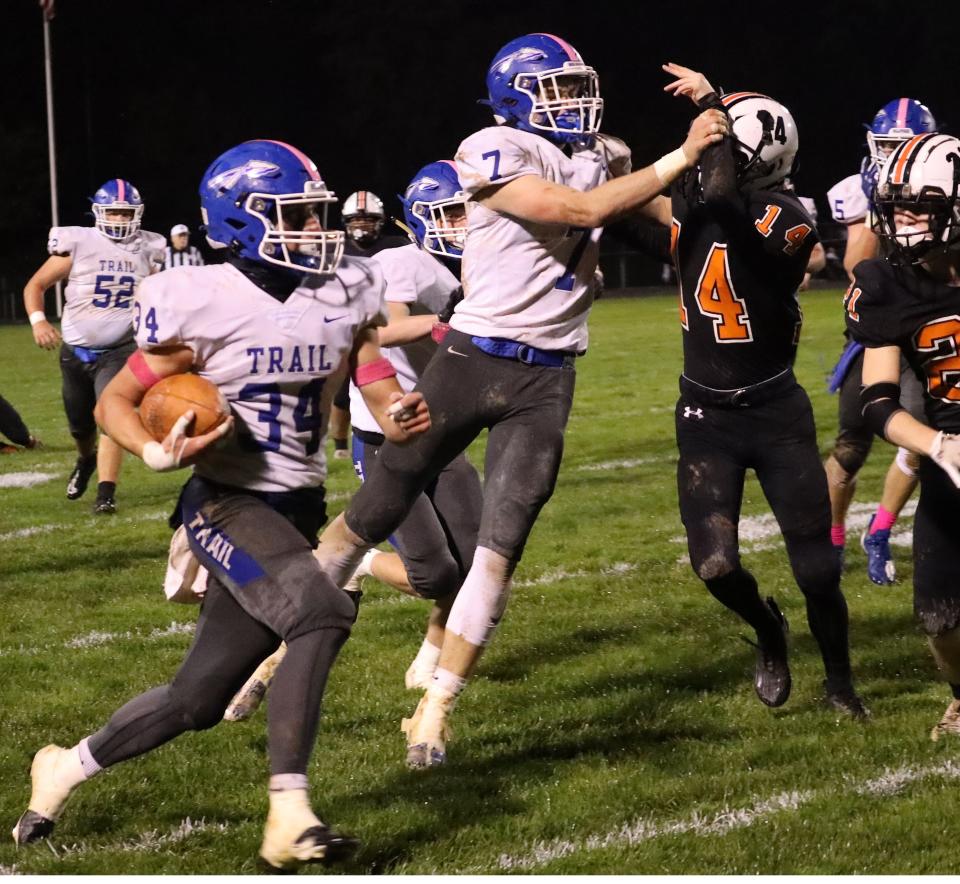 Buckeye Trail's Koen Eagon (34) makes his way through the line during the regular season finale at Newcomerstown. Eagon along with Warrior teammates Charlie Parry, Brady Hastings and Jackson Hess were each named to the First Team All-IVC  in the North Division for the past season.