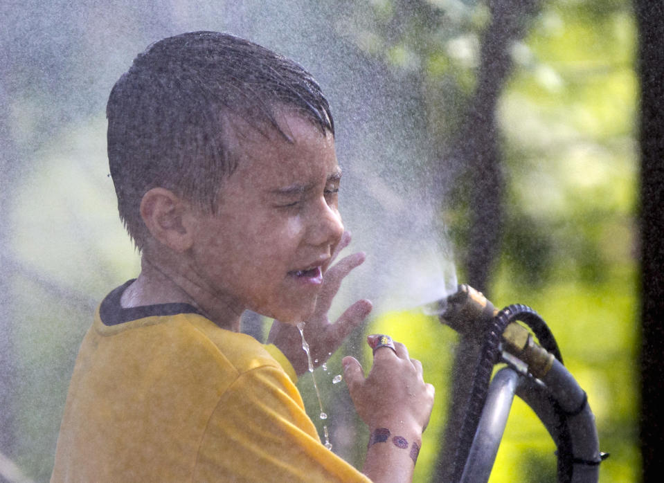  <p> FILE - This July 6, 2012 file photo shows six-year-old Alexander Merrill of Sioux Falls, S.D., cooling off in a cloud of mist at the Henry Doorly Zoo in Omaha, Neb., as temperatures reached triple digits. Federal meteorologists say America was deep fried in 2012, becoming the hottest year on record by far. The National Climatic Data Center in Ashville, N.C., calculates that the average U.S. temperature in 2012 was 55.32 degrees Fahrenheit. That's a full degree warmer than the previous record of 1998. Normally, records are broken by about a tenth of a degree. (AP Photo/Nati Harnik, File) </p>