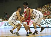 Manny Pacquiao, a playing coach of KIA-Sorento, is guarded by players of Blackwater-Elite during the first quarter of the 40th Season of the Philippine Basketball Association (PBA) games in Bocaue town, Bulacan province, north of Manila October 19, 2014. Pacquiao, a congressman and a world renowned boxing champion, ventured into the PBA as a playing coach on Sunday. Manny Pacquiao is scheduled for a title bout against Chris Algieri of the U.S. in Macau on November 22. REUTERS/Romeo Ranoco (PHILIPPINES - Tags: SPORT BOXING POLITICS BASKETBALL)